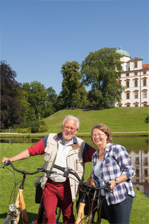 Paar mit dem Fahrrad vor dem Schloss Celle (Foto: Nina Weymann)